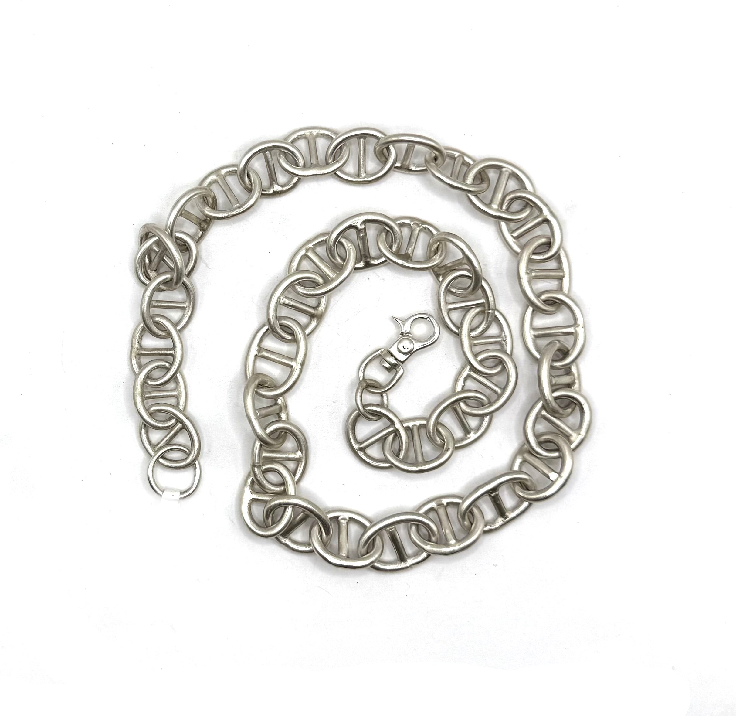 Silver chain necklace on a white background