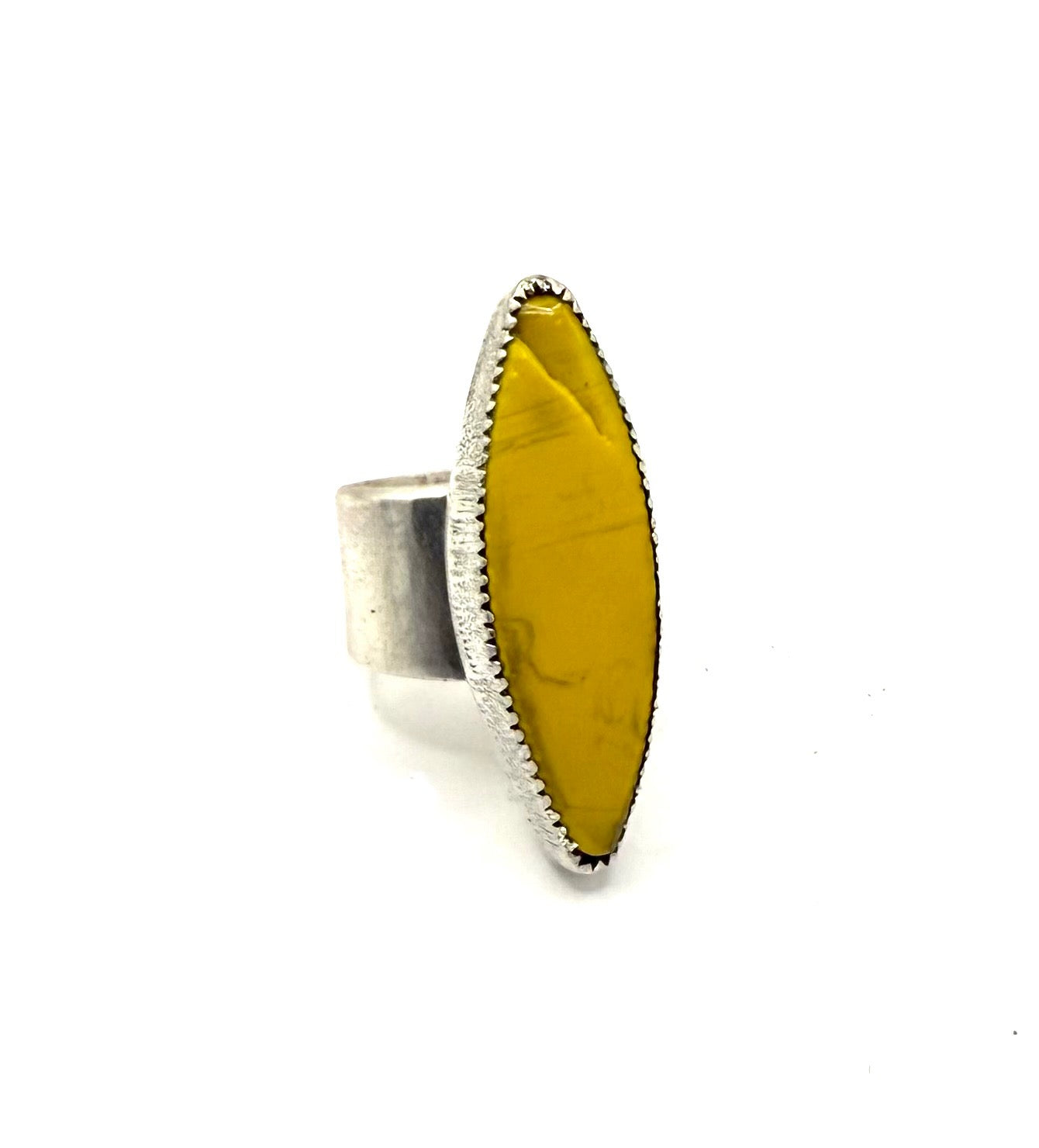 Ring with a yellow stone and silver band on a white background