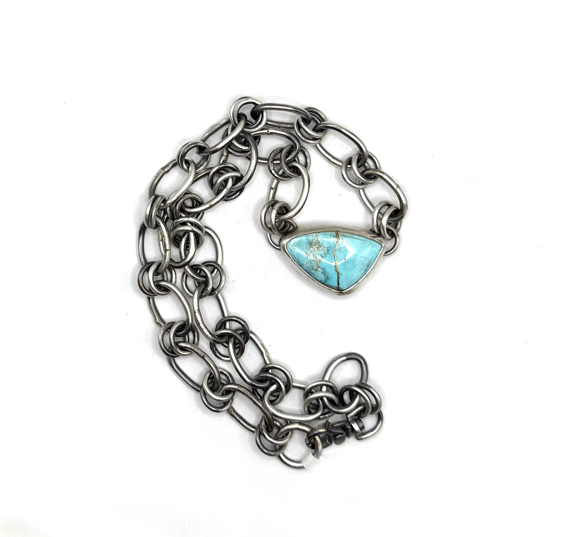 Chain bracelet with a heart-shaped turquoise stone on a white background