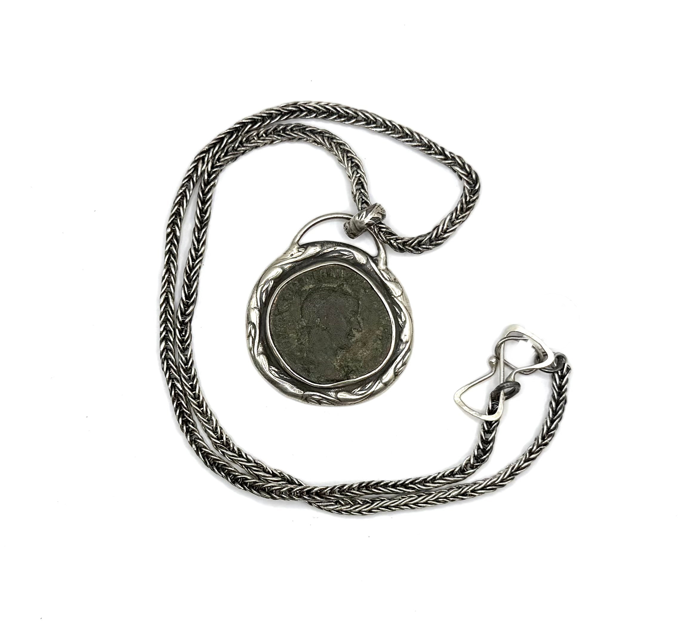 Silver necklace with a pendant on a white background