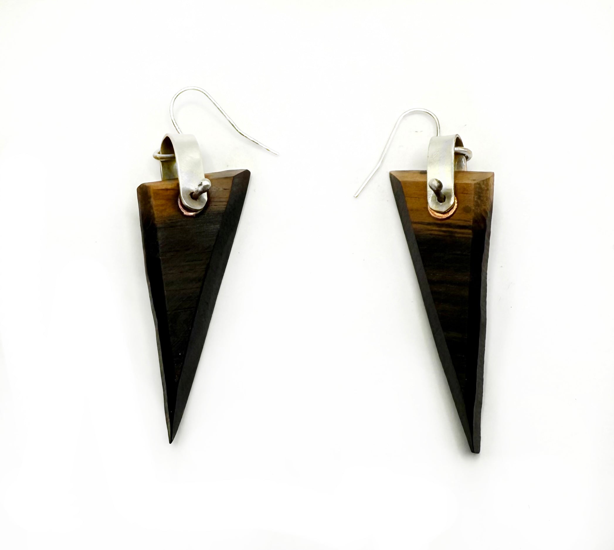 Tribal-style wooden earrings on a white background