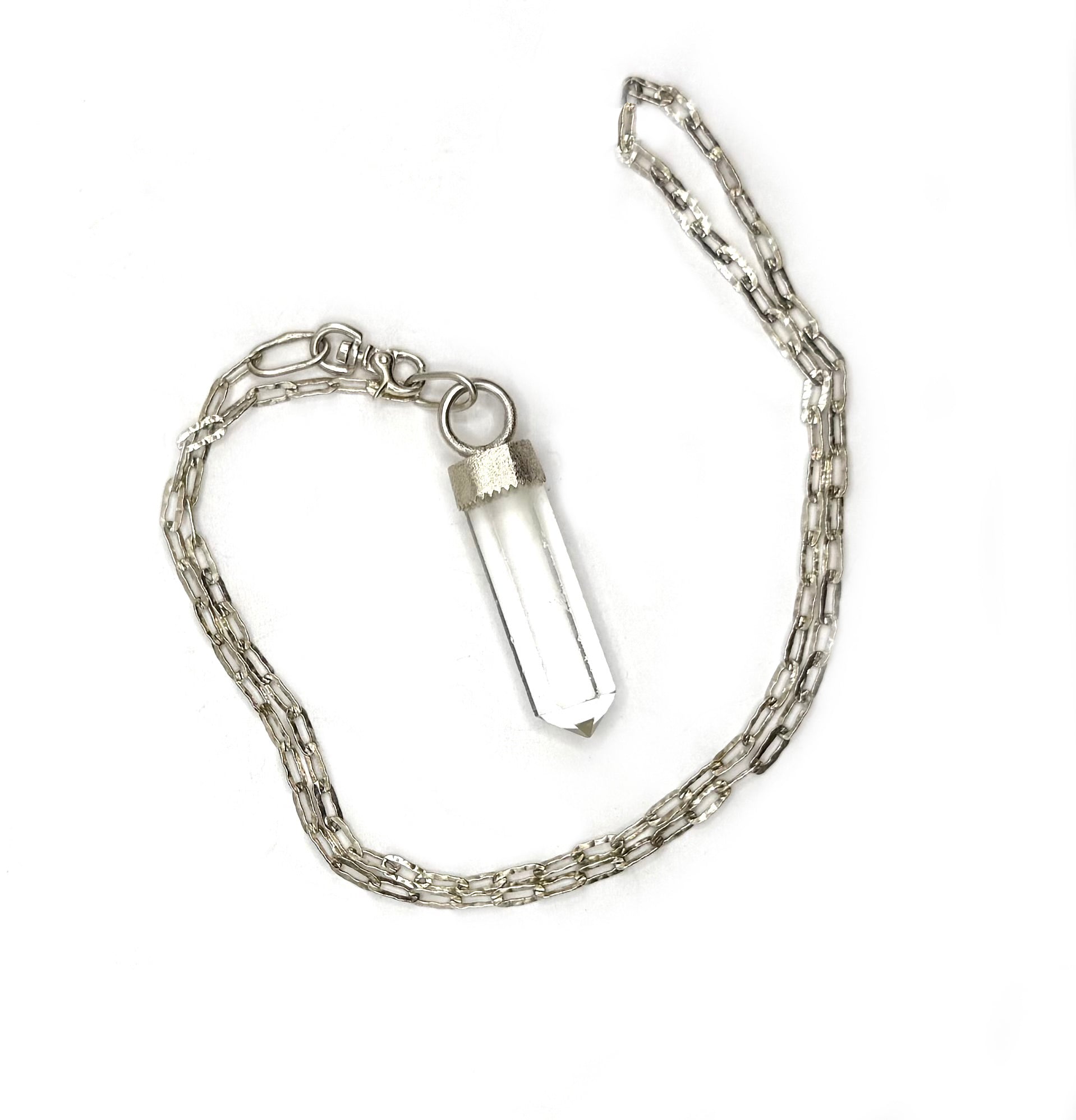 Silver chain necklace with a clear crystal pendant on a white background