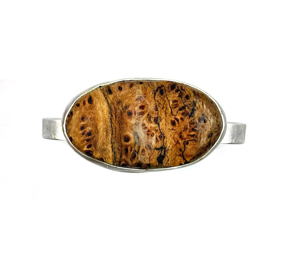 Wooden oval object with silver frame on a white background