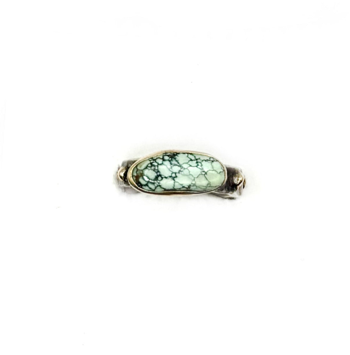 Ring with a green gemstone on a white background
